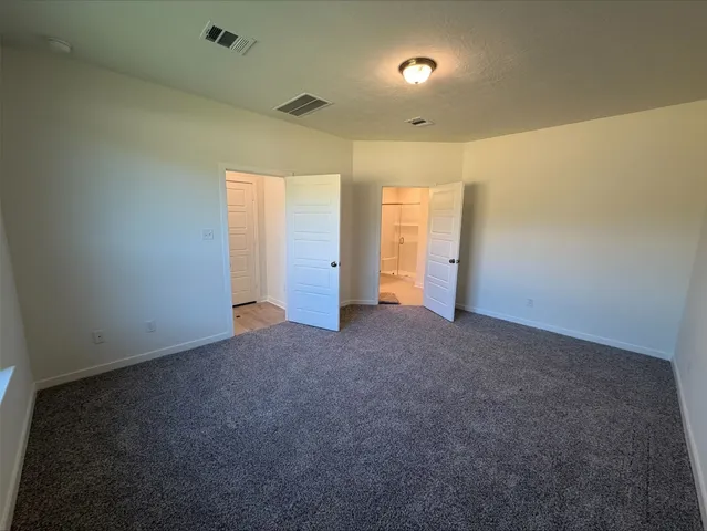 an empty room with closet and wooden floor