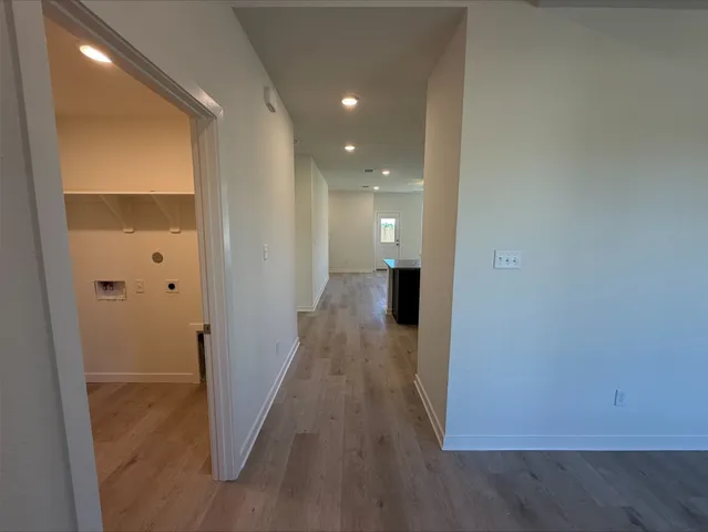 a view of hallway with wooden floor
