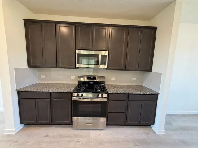 a kitchen with a stove and a microwave
