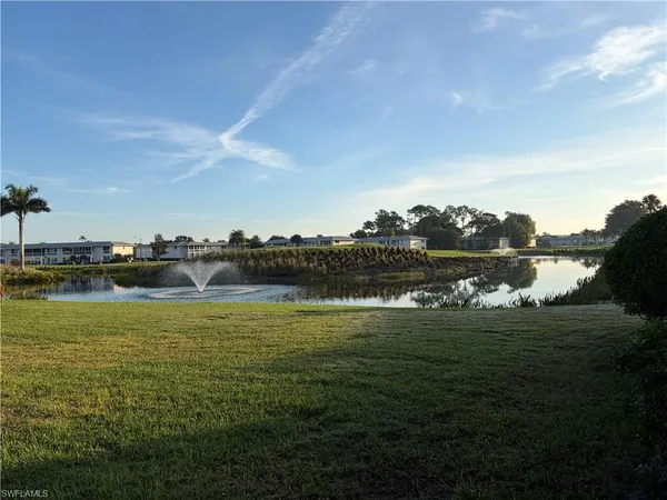a view of a lake with houses in back