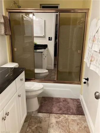 a dining room with furniture and a floor to ceiling window