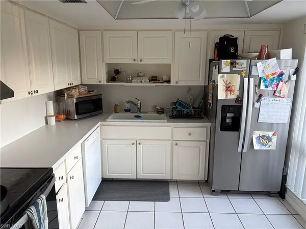 a kitchen with stainless steel appliances a refrigerator sink and cabinets