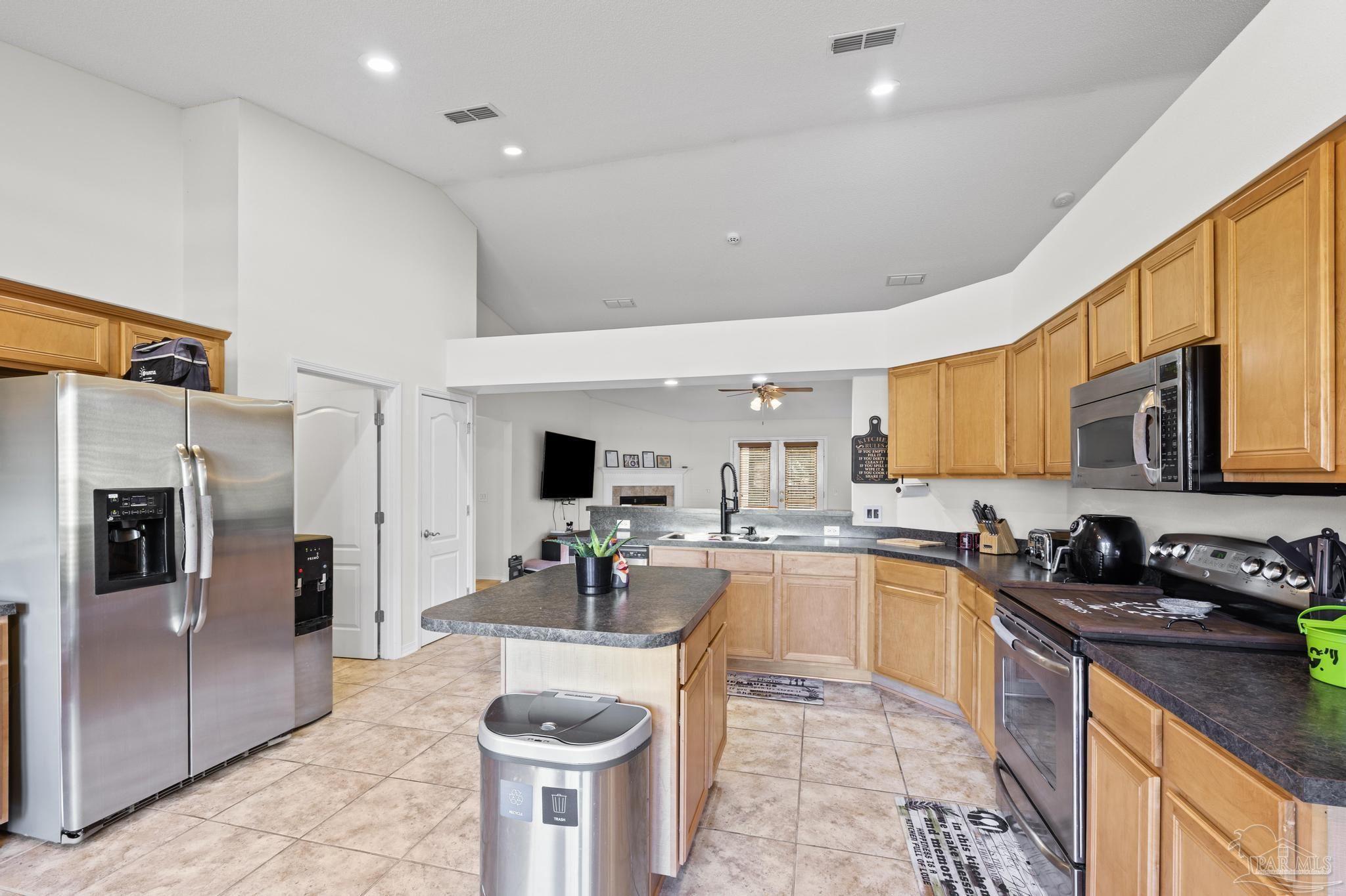 2165 Liberty Loop Road Cantonment, FL 32533 - Photo 23 of 51 a kitchen with stainless steel appliances granite countertop a sink stove and refrigerator