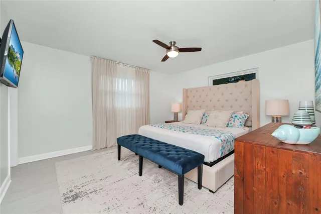 a bedroom with a bed a dresser and a window