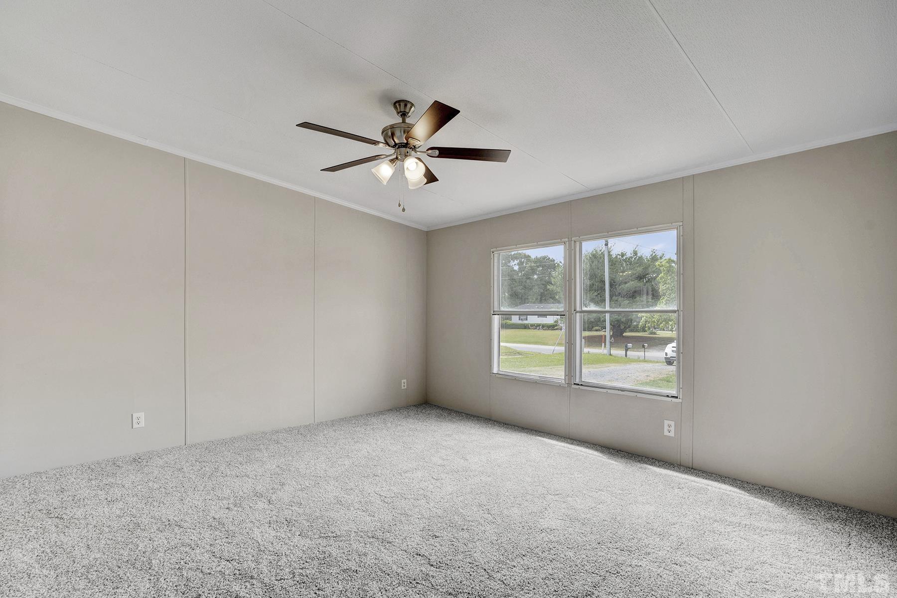 105 Rains Crossroads Road Selma, NC 27576 - Photo 19 of 30 a view of room with a ceiling fan and window