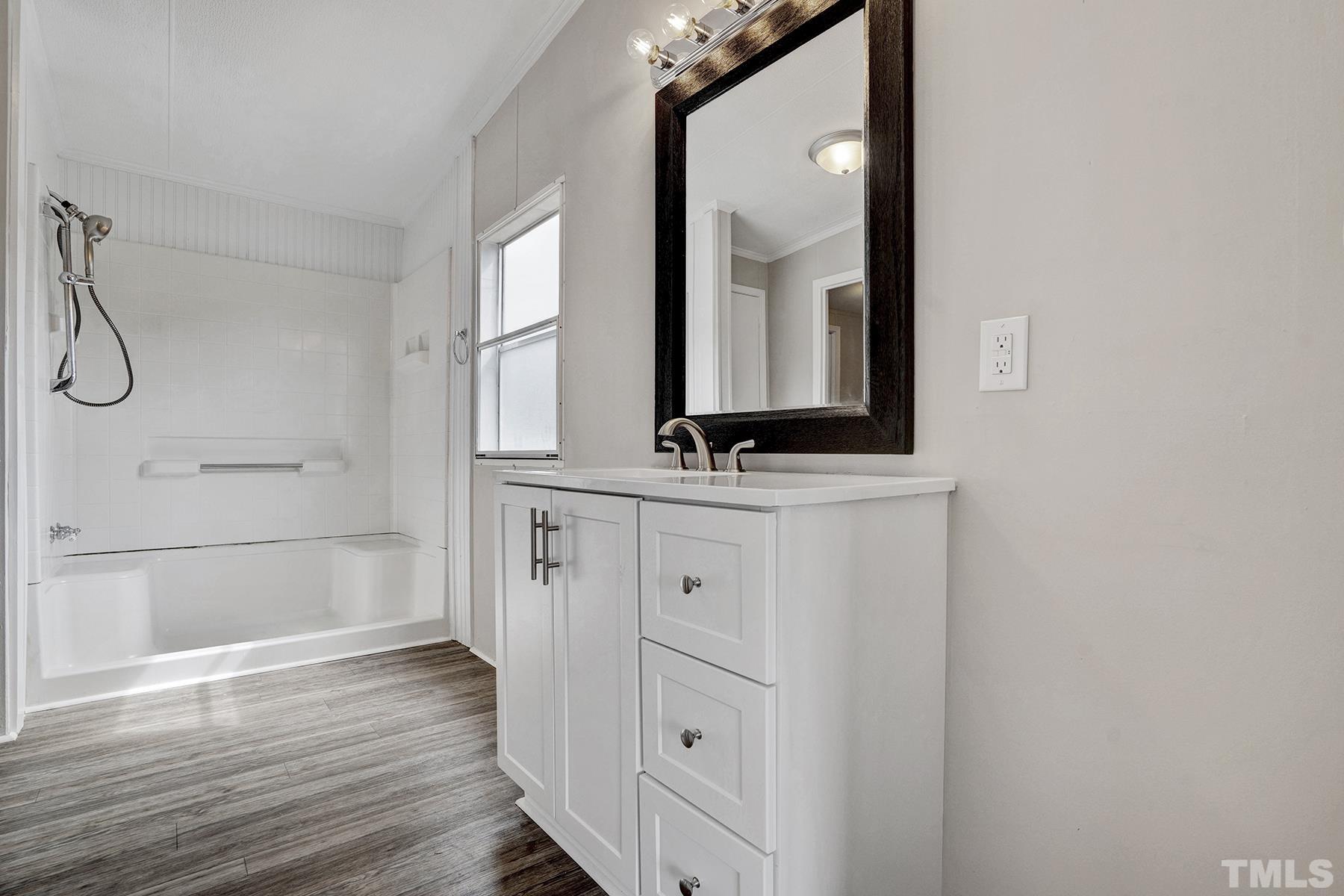 105 Rains Crossroads Road Selma, NC 27576 - Photo 21 of 30 a bathroom with a mirror a vanity and a shower