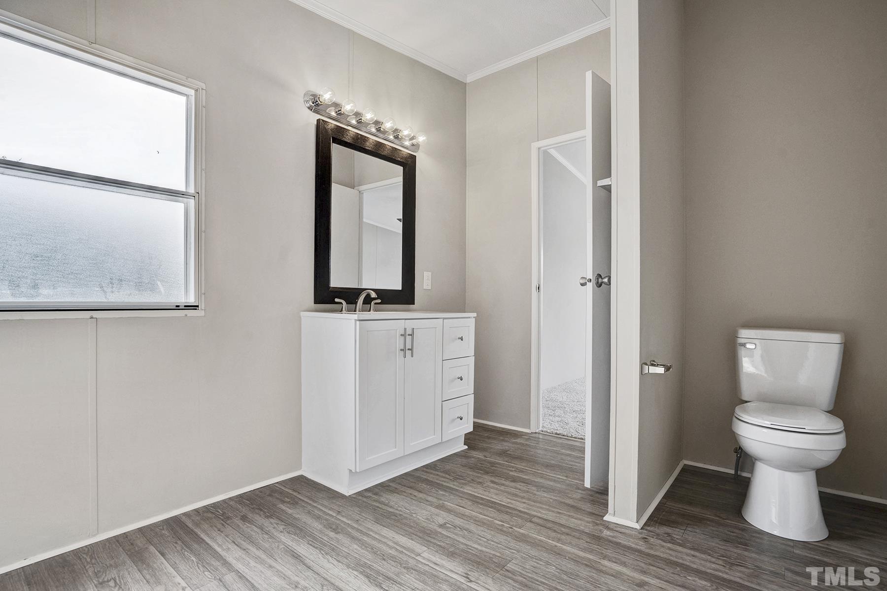 105 Rains Crossroads Road Selma, NC 27576 - Photo 22 of 30 a bathroom with a toilet and a mirror