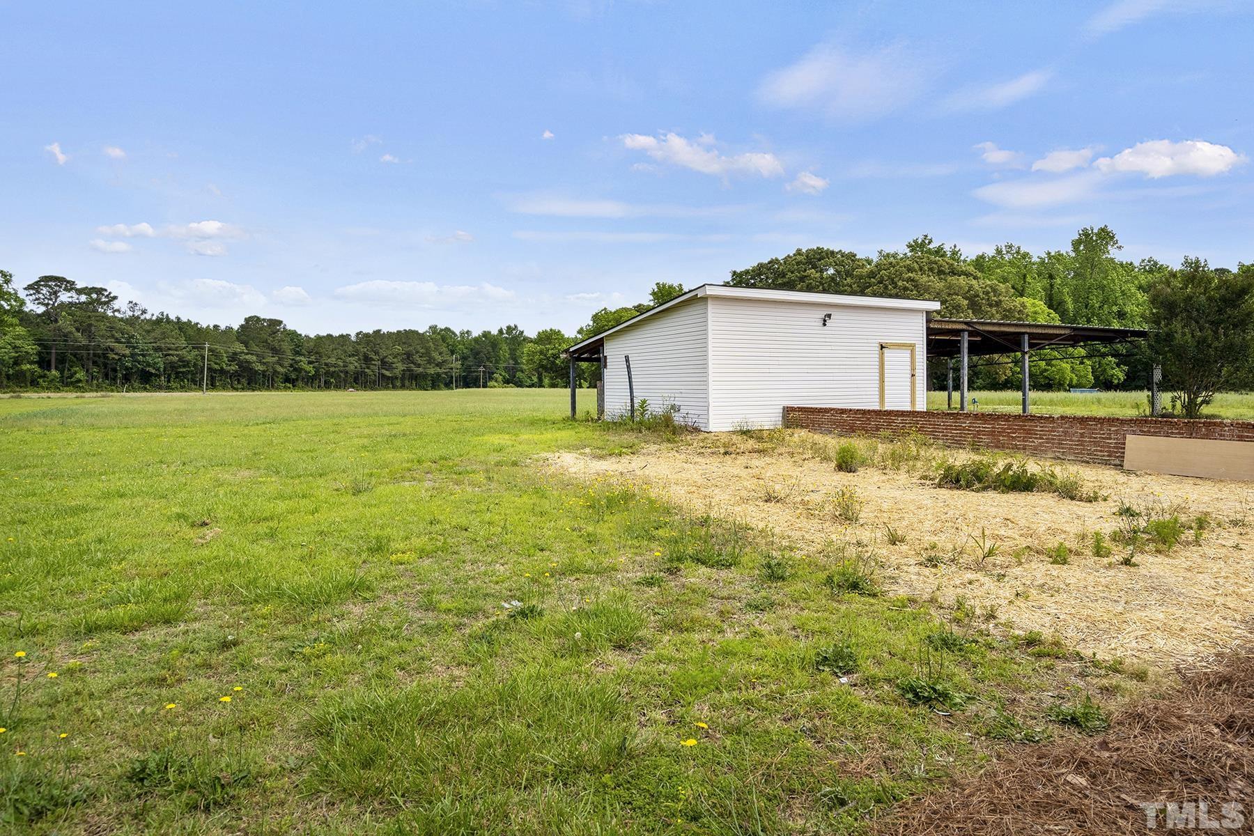 105 Rains Crossroads Road Selma, NC 27576 - Photo 27 of 30 a view of a yard with a house in the background