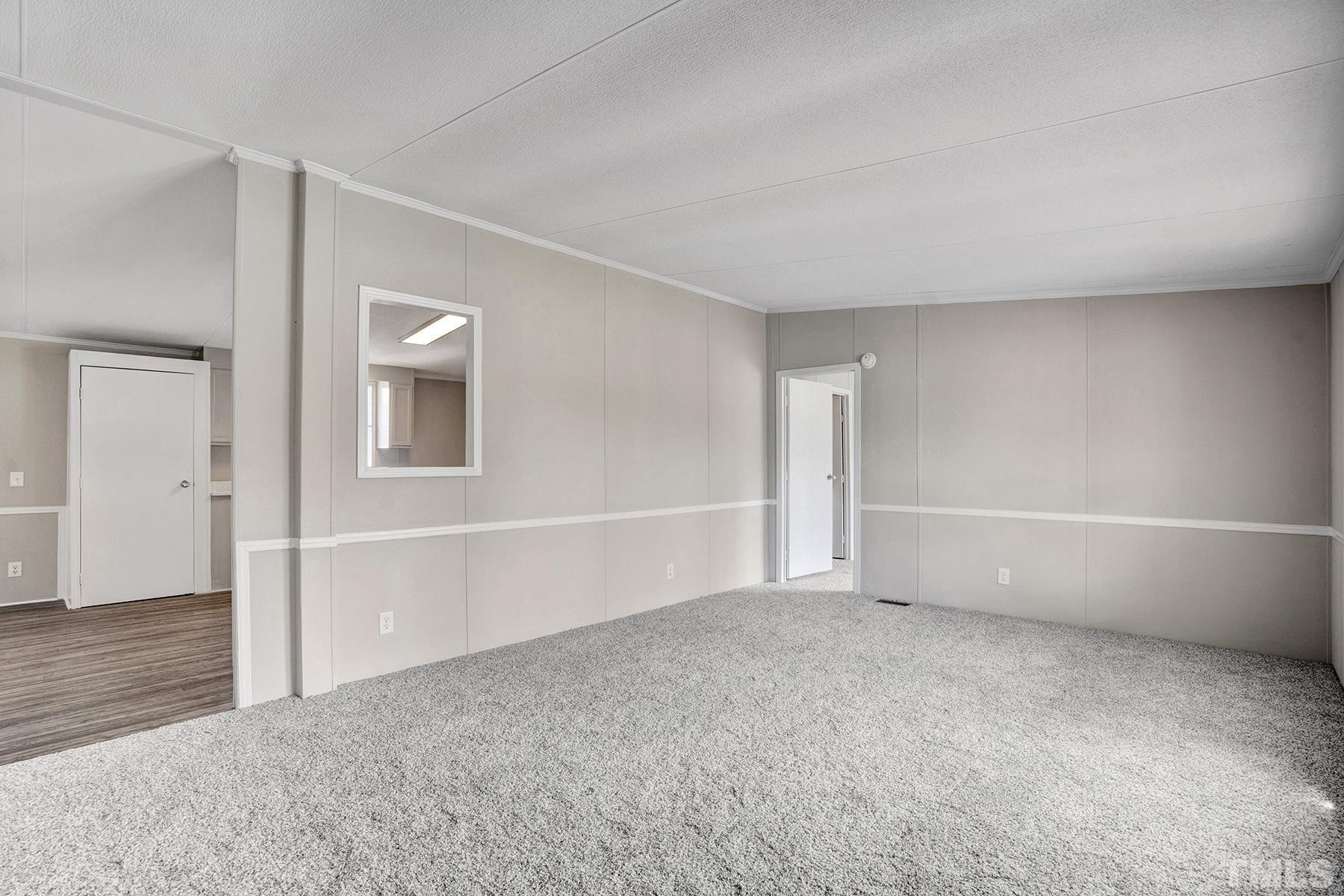 105 Rains Crossroads Road Selma, NC 27576 - Photo 6 of 30 an empty room with a empty space and windows