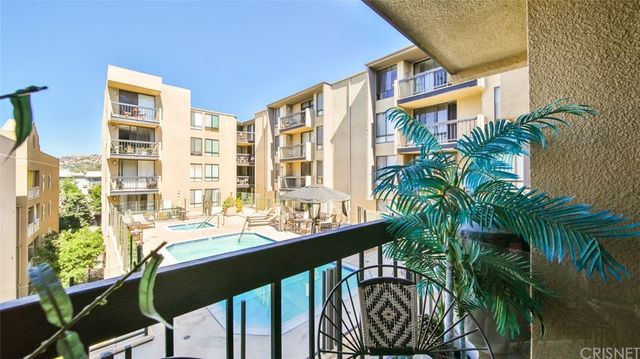 a dining room filled with lots of potted plants and a large window