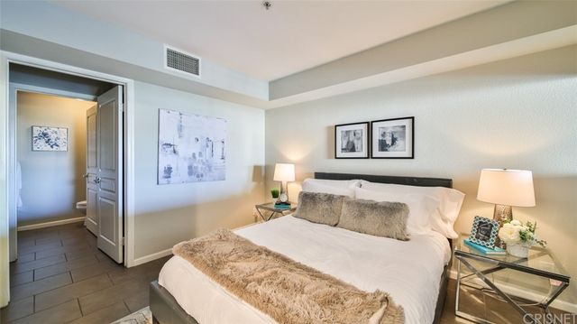 a bedroom with a bed and lamp