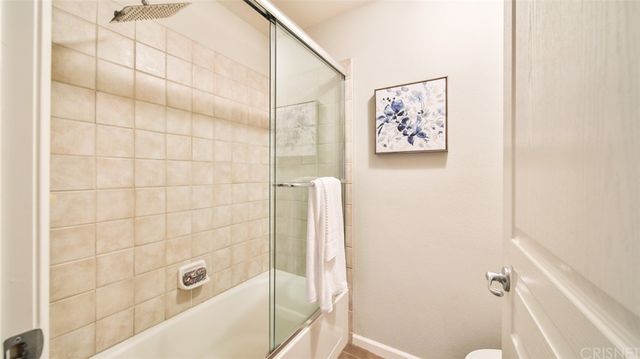 a bathroom with a bathtub and shower
