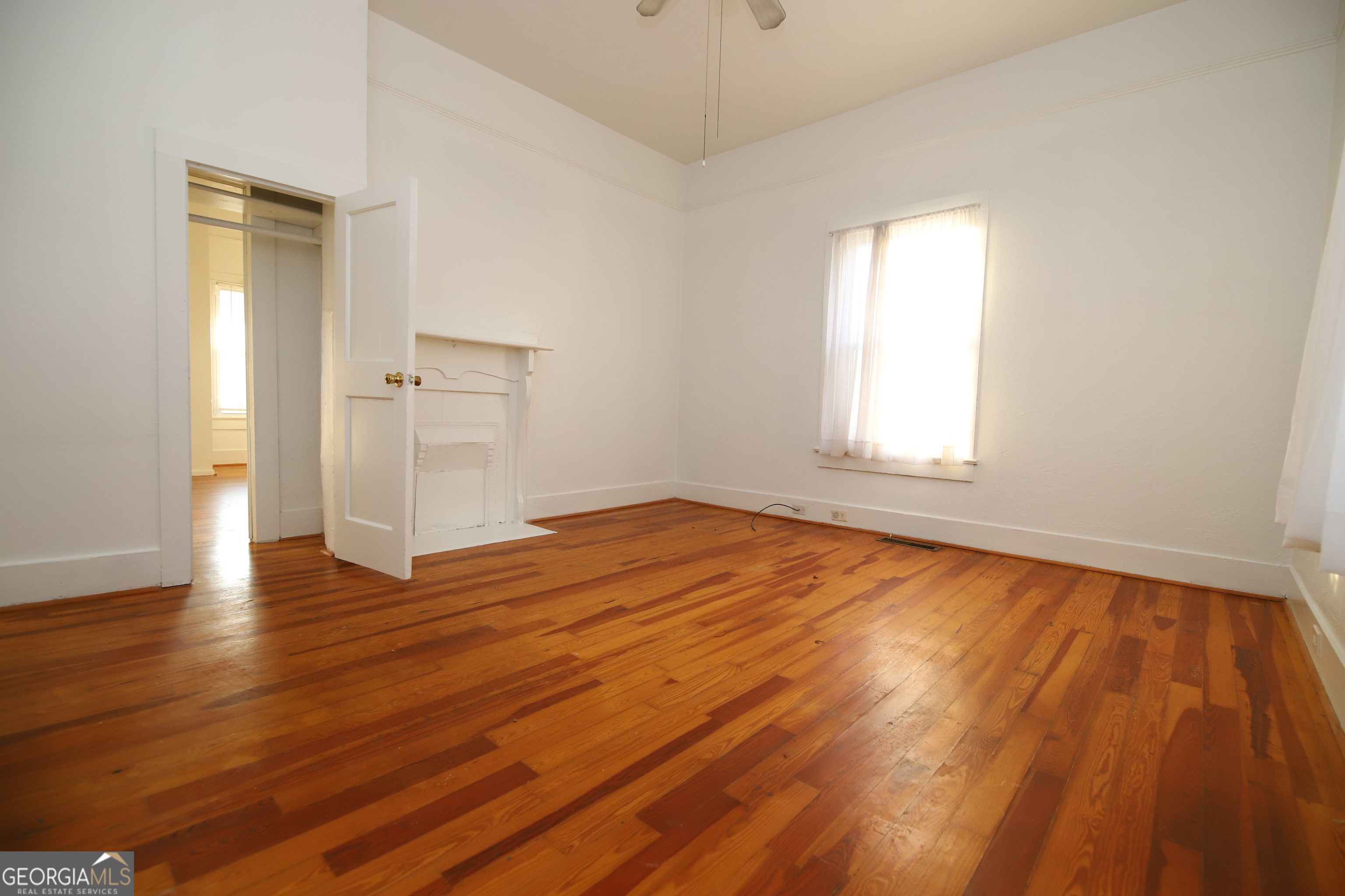 201 Jennings Street Valley, AL 36854 - Photo 15 of 24 an empty room with wooden floor and windows