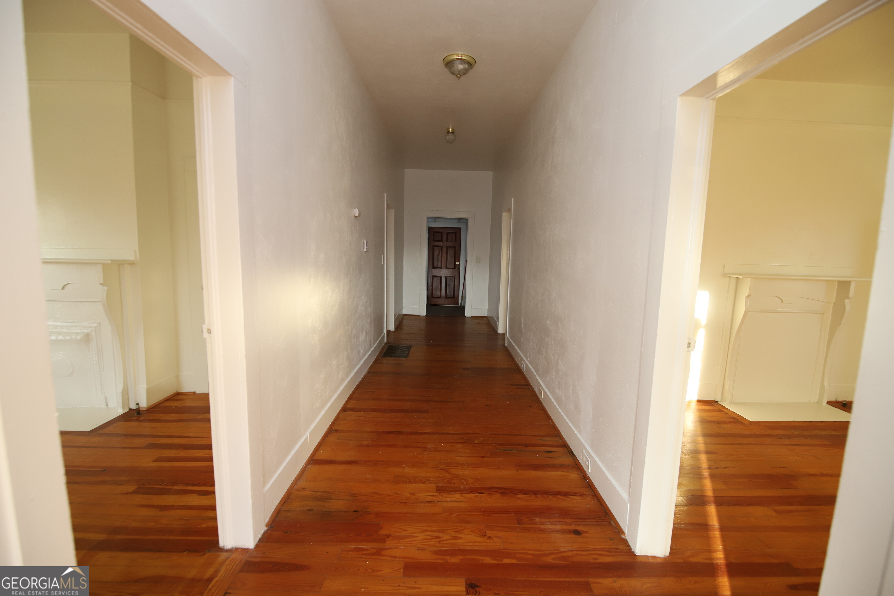 201 Jennings Street Valley, AL 36854 - Photo 17 of 24 a view of a hallway with wooden floor and staircase