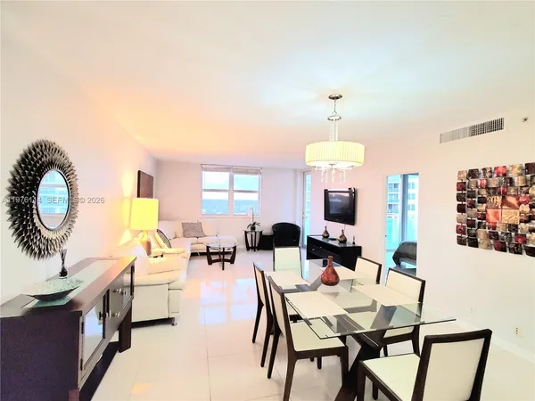 a view of a dining room with furniture and a chandelier