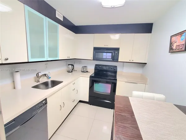 a kitchen with stainless steel appliances a sink stove and cabinets