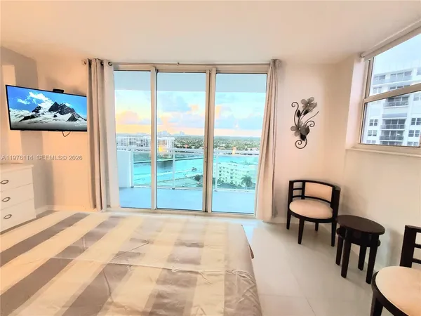 a view of a bedroom with furniture and window