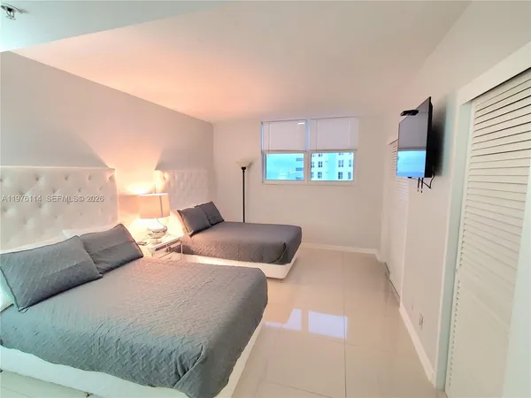 a bedroom with a bed and a couch