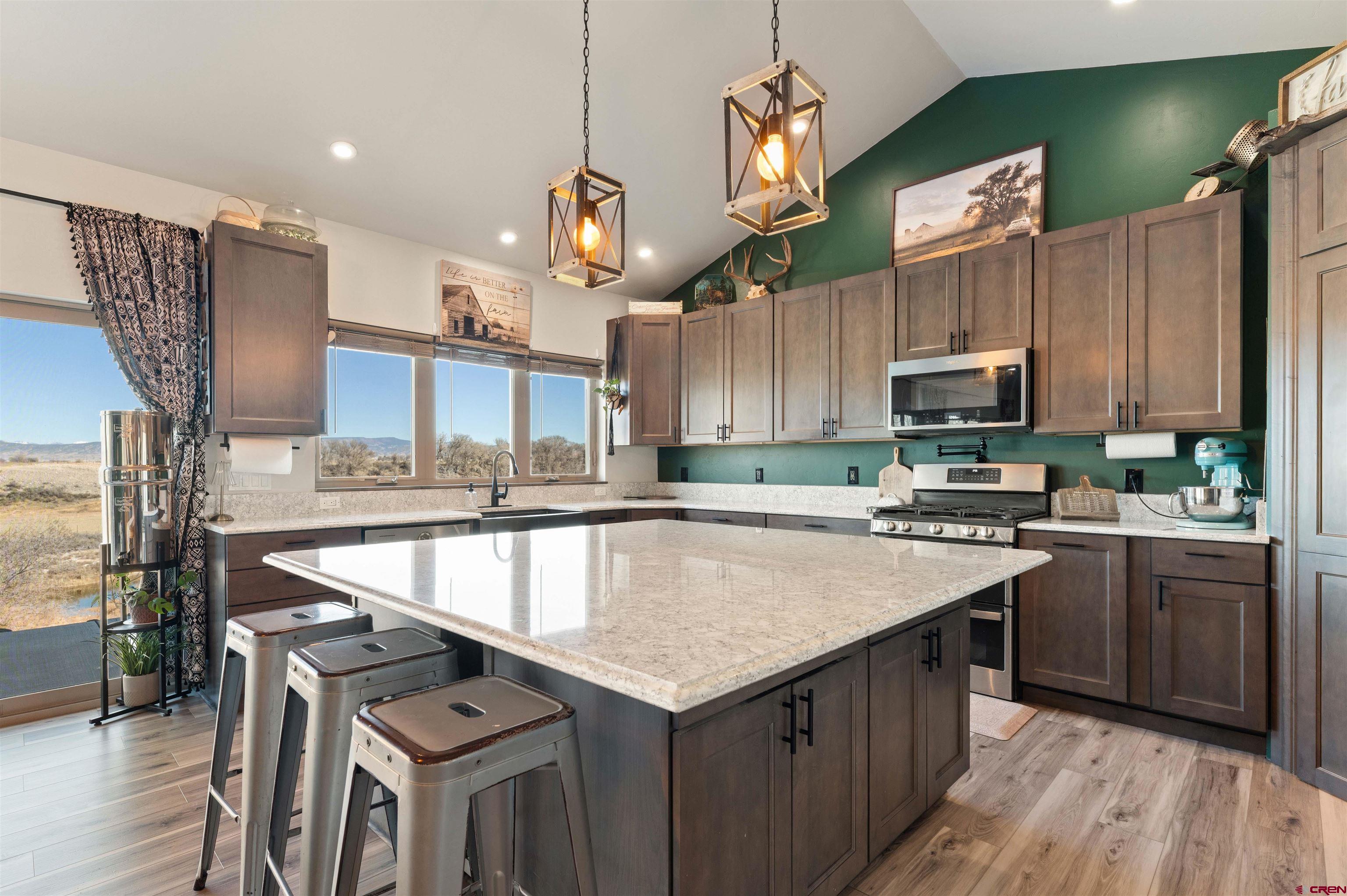 55347 Begonia Road Delta, CO 81416 - Photo 28 of 44 a kitchen with a stove a sink and a refrigerator