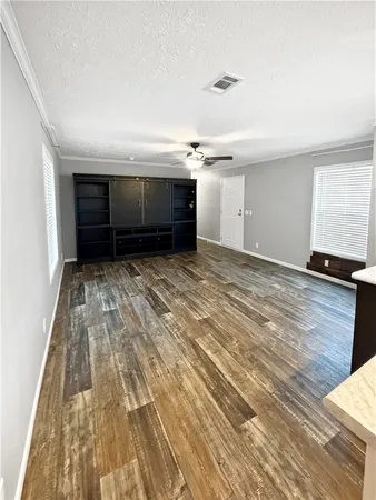 a view of room with wooden floor and ceiling fan