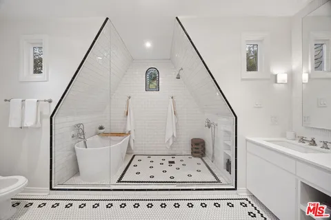 a view of kitchen with sink and mirror
