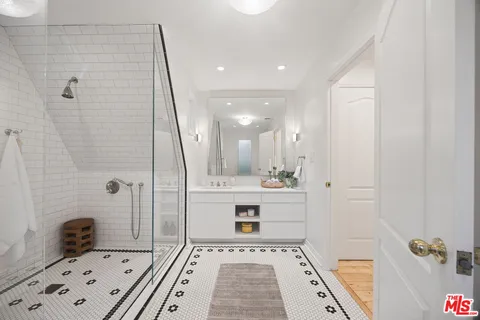 a bathroom with a tub sink and mirror