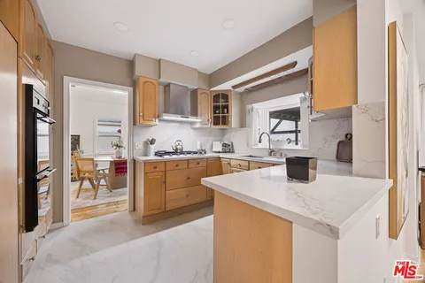 a kitchen with a sink a stove and refrigerator