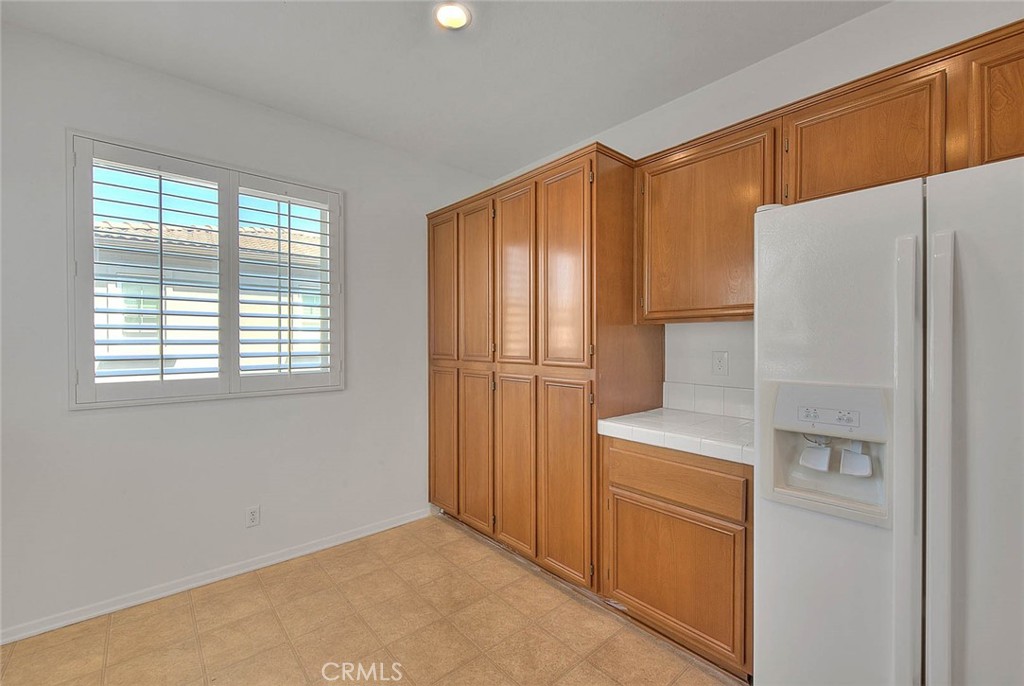 8150 West Preserve Loop Chino, CA 91708 - Photo 22 of 51 a kitchen with a refrigerator a washer and dryer