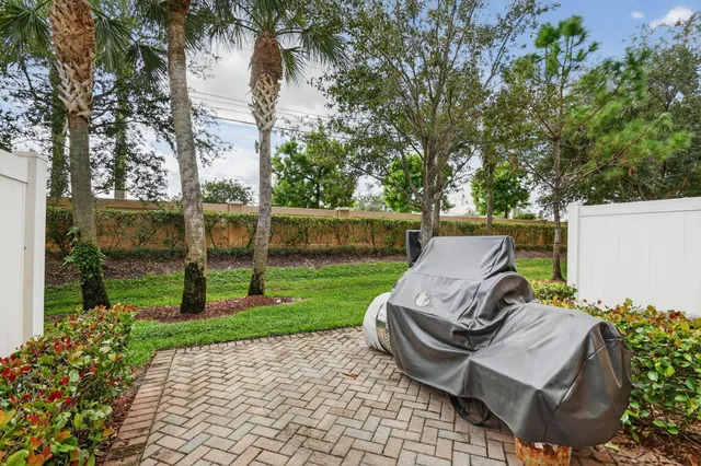 a view of a yard with furniture and garden