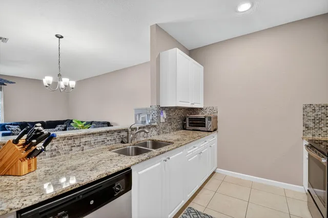 a kitchen with a sink a counter top stainless steel appliances and cabinets