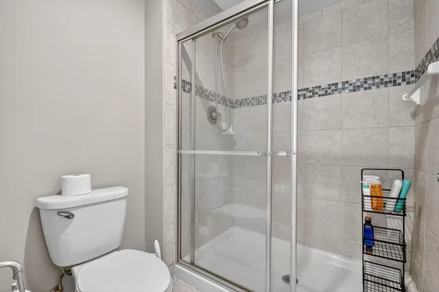 a bathroom with a toilet and a shower