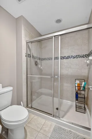 a bathroom with a shower and a toilet