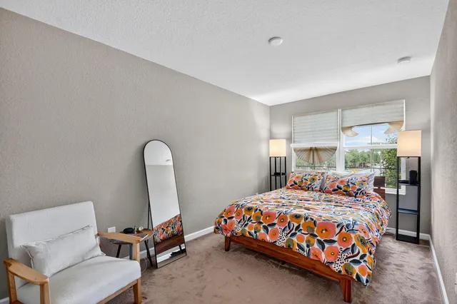 a bedroom with a bed and a chair