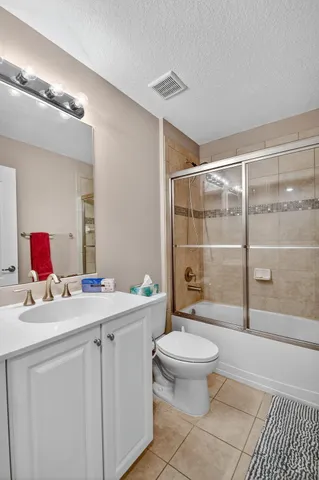 a bathroom with a sink toilet vanity and shower