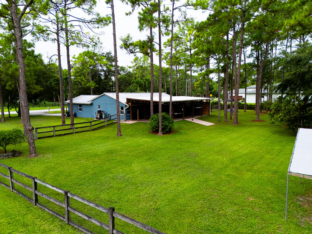 15733 Temple Boulevard Loxahatchee, FL 33470 - Photo 25 of 27 a view of a house with backyard and sitting area