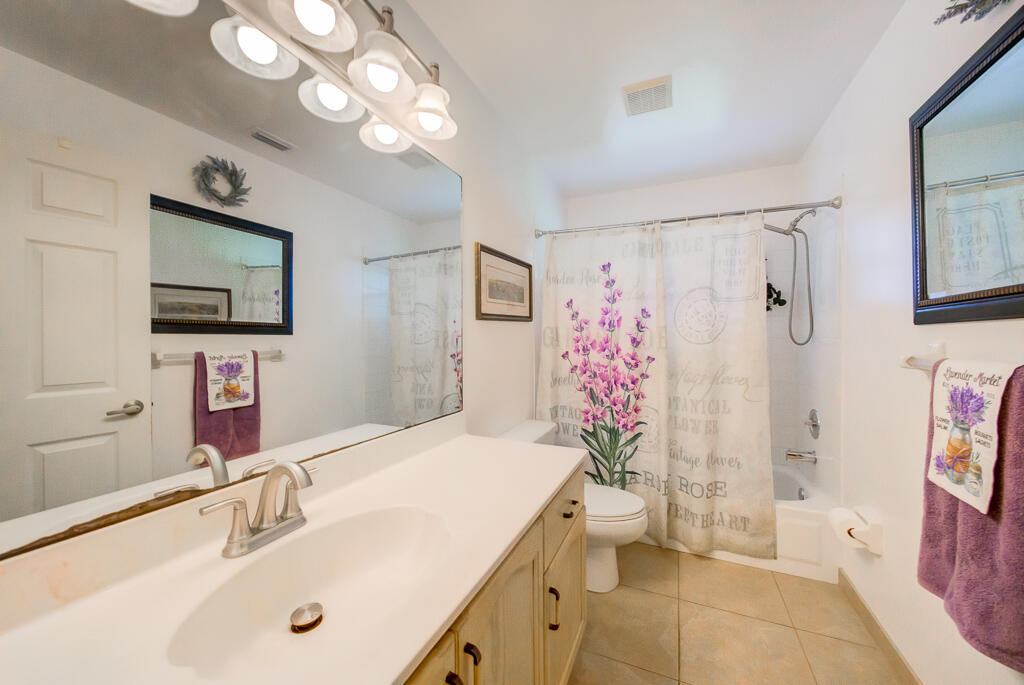 15733 Temple Boulevard Loxahatchee, FL 33470 - Photo 6 of 27 a bathroom with a sink a toilet and a large mirror