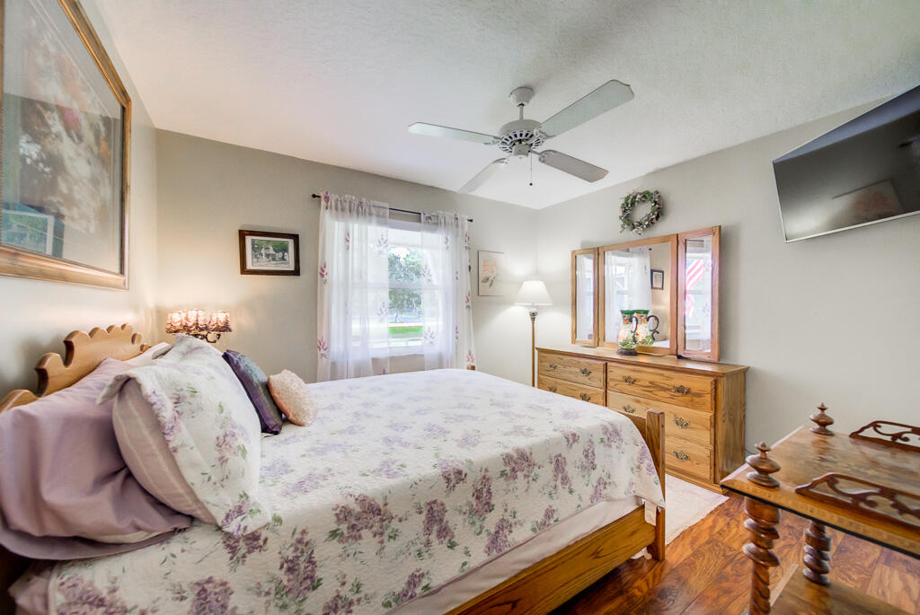 15733 Temple Boulevard Loxahatchee, FL 33470 - Photo 7 of 27 a bedroom with a bed and a flat screen tv