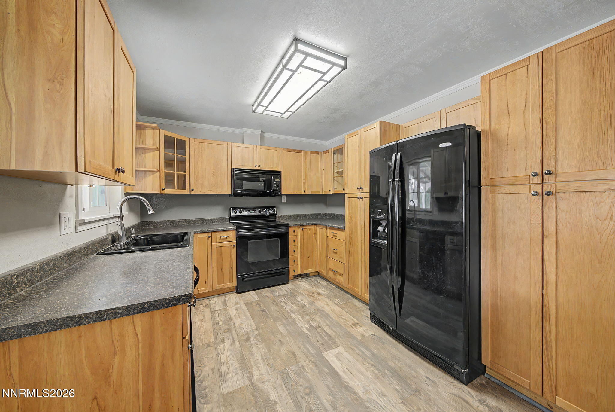 11577 Deodar Way Reno, NV 89506 - Photo 15 of 58 a kitchen with granite countertop stainless steel appliances and wooden cabinets
