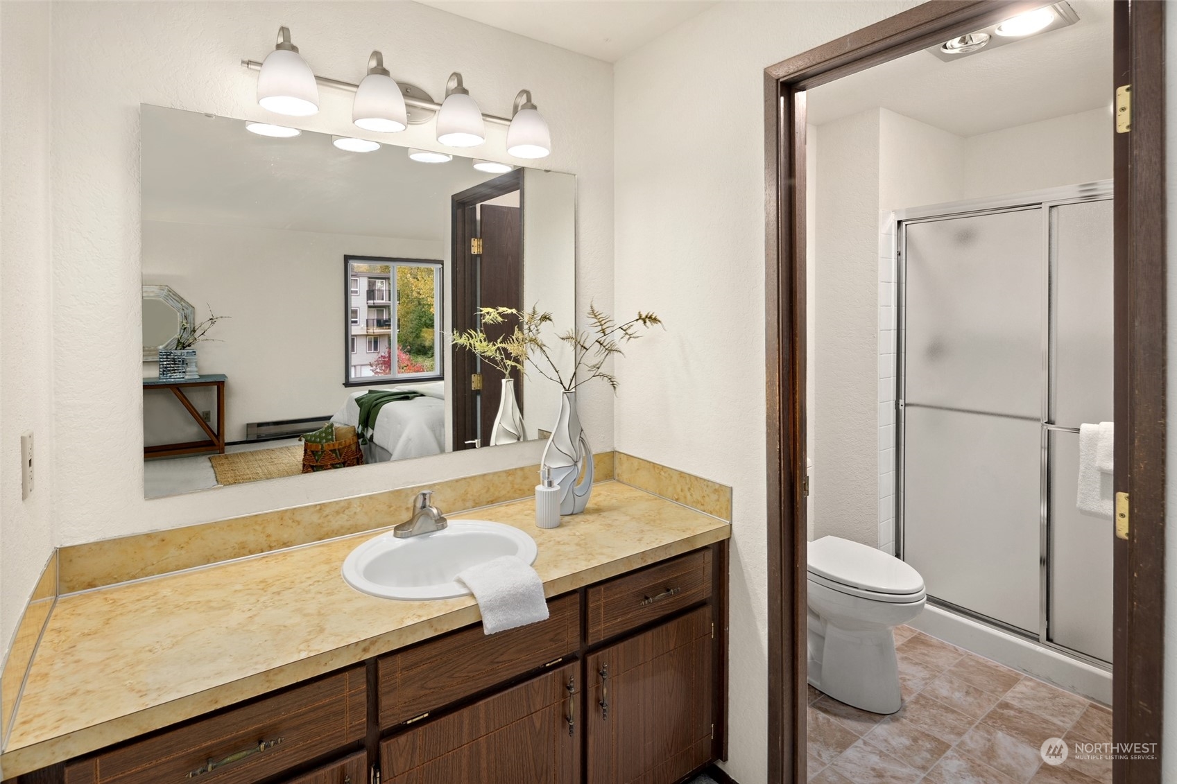 4100 Lake Washington Boulevard North, Unit A202 Renton, WA 98056 - Photo 15 of 25 a bathroom with a granite countertop sink a toilet and a mirror