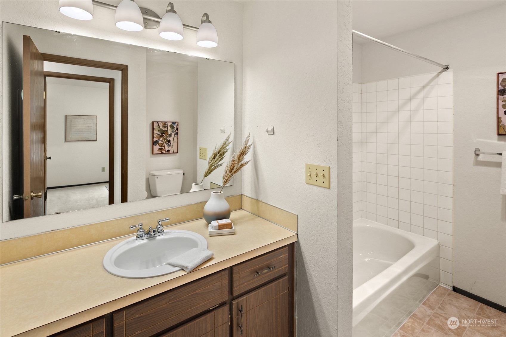 4100 Lake Washington Boulevard North, Unit A202 Renton, WA 98056 - Photo 18 of 25 a bathroom with a sink vanity tub and a mirror