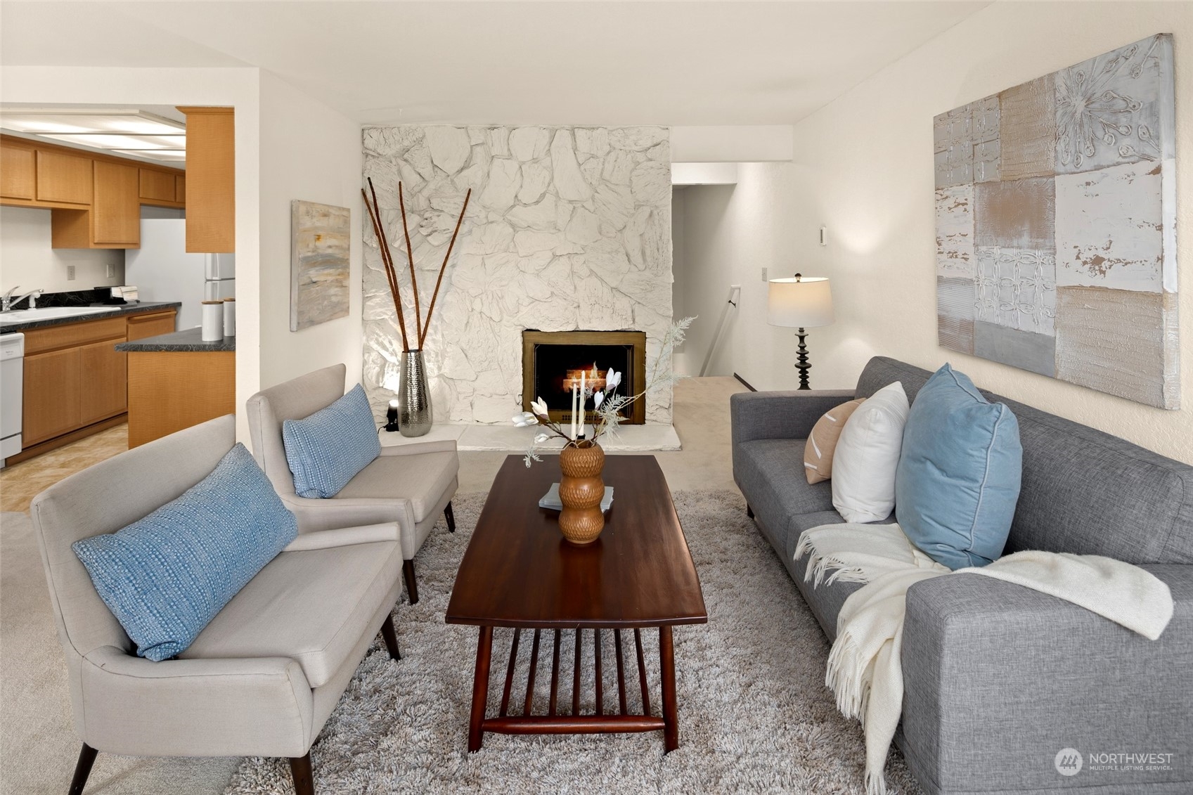 4100 Lake Washington Boulevard North, Unit A202 Renton, WA 98056 - Photo 2 of 25 a living room with furniture and a fireplace