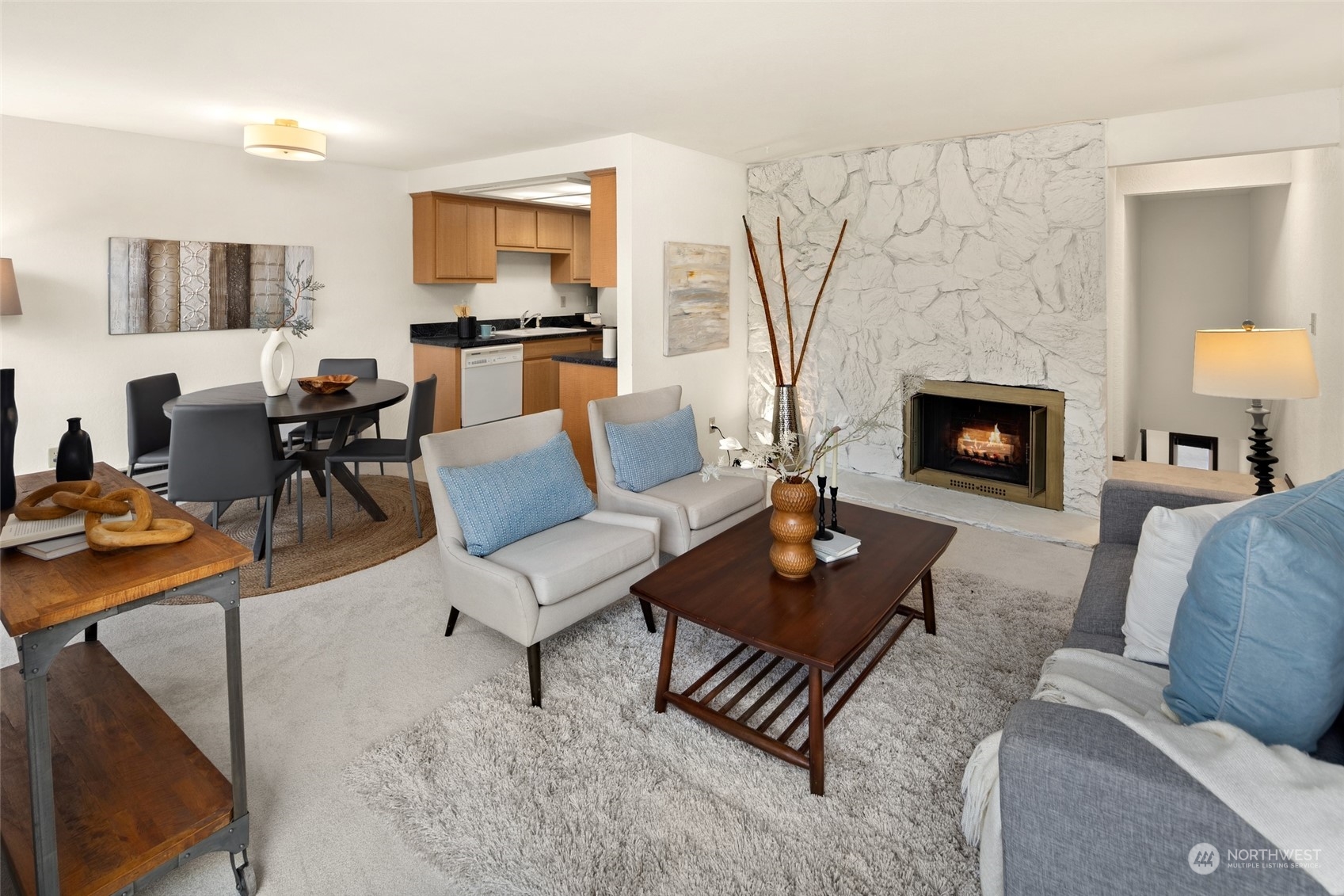 4100 Lake Washington Boulevard North, Unit A202 Renton, WA 98056 - Photo 4 of 25 a living room with furniture and a fireplace