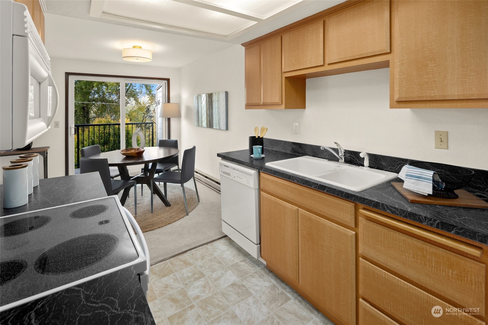 4100 Lake Washington Boulevard North, Unit A202 Renton, WA 98056 - Photo 9 of 25 a kitchen with sink cabinets and outdoor view