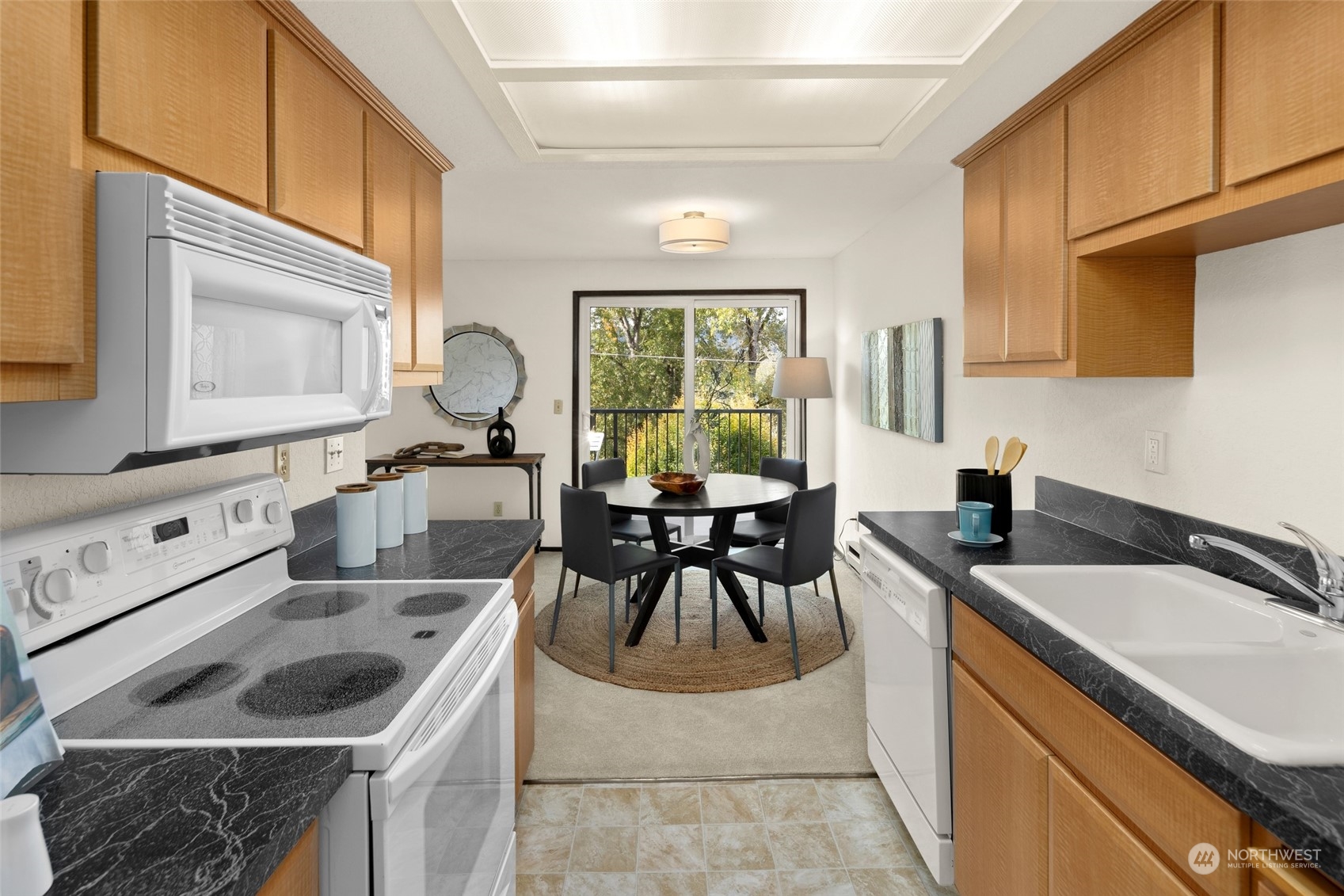 4100 Lake Washington Boulevard North, Unit A202 Renton, WA 98056 - Photo 10 of 25 a kitchen with a stove a sink and a refrigerator