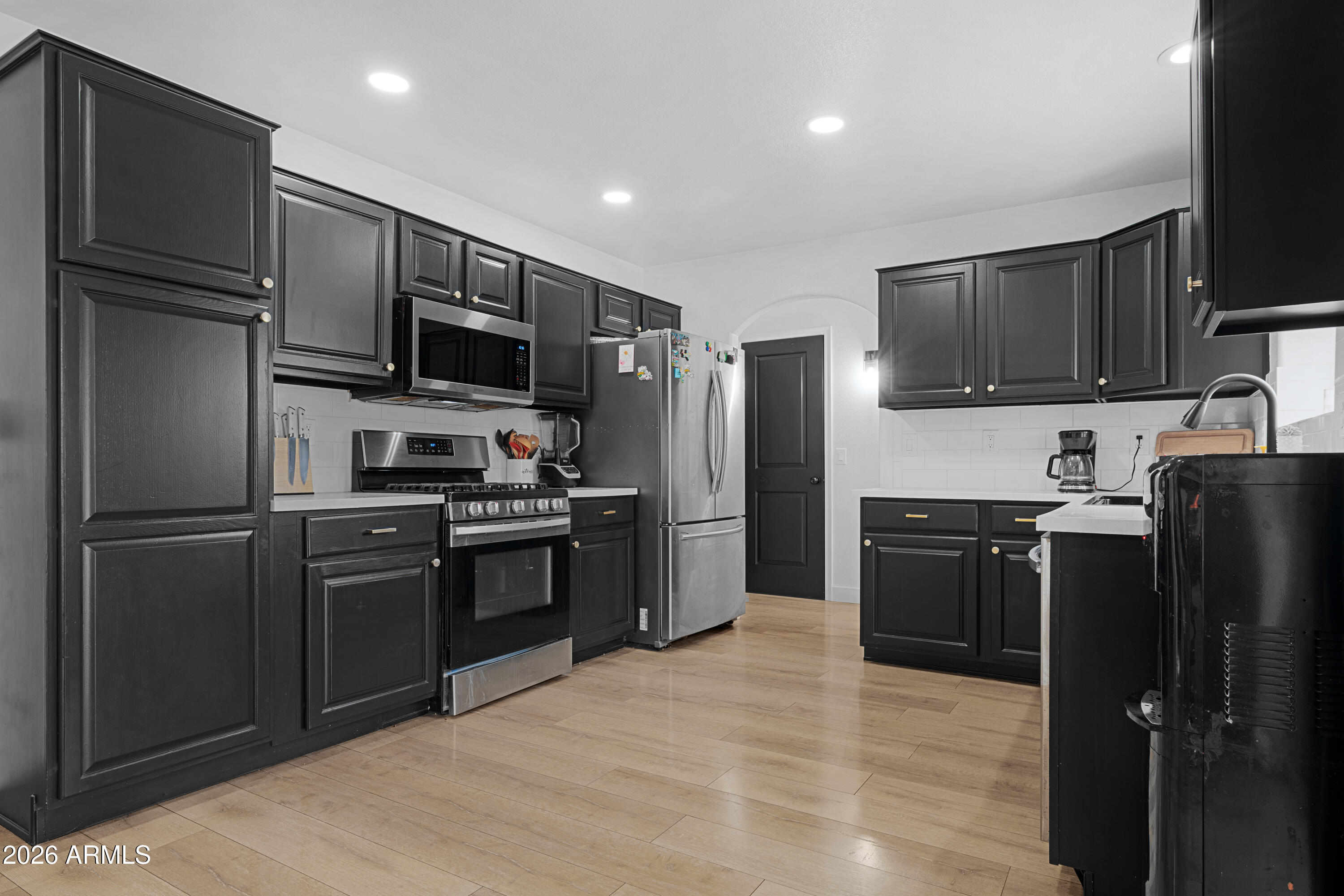 1810 East Milky Way Gilbert, AZ 85295 - Photo 11 of 46 a kitchen with stainless steel appliances granite countertop a refrigerator stove and microwave