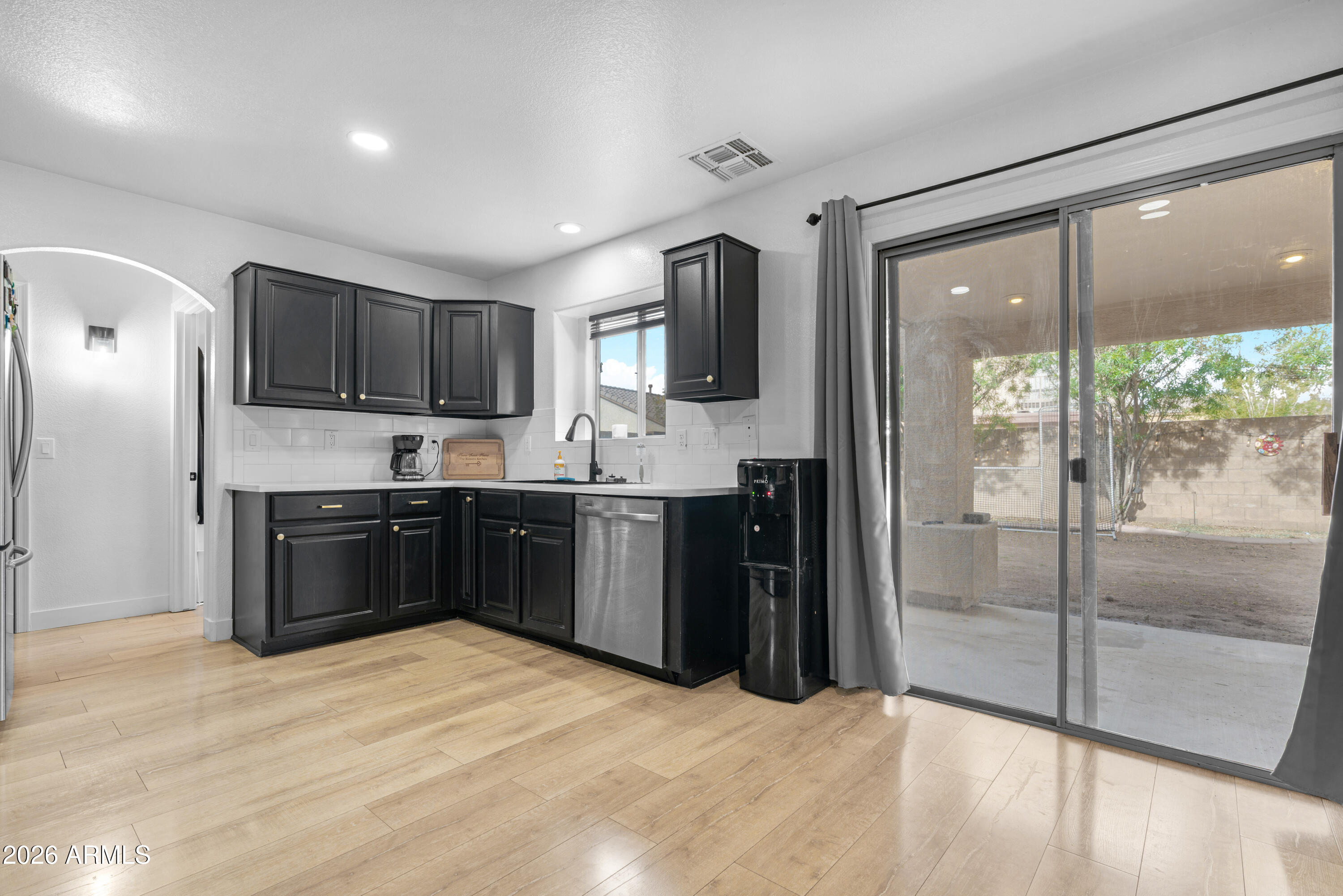 1810 East Milky Way Gilbert, AZ 85295 - Photo 13 of 46 a kitchen with a refrigerator and a stove top oven