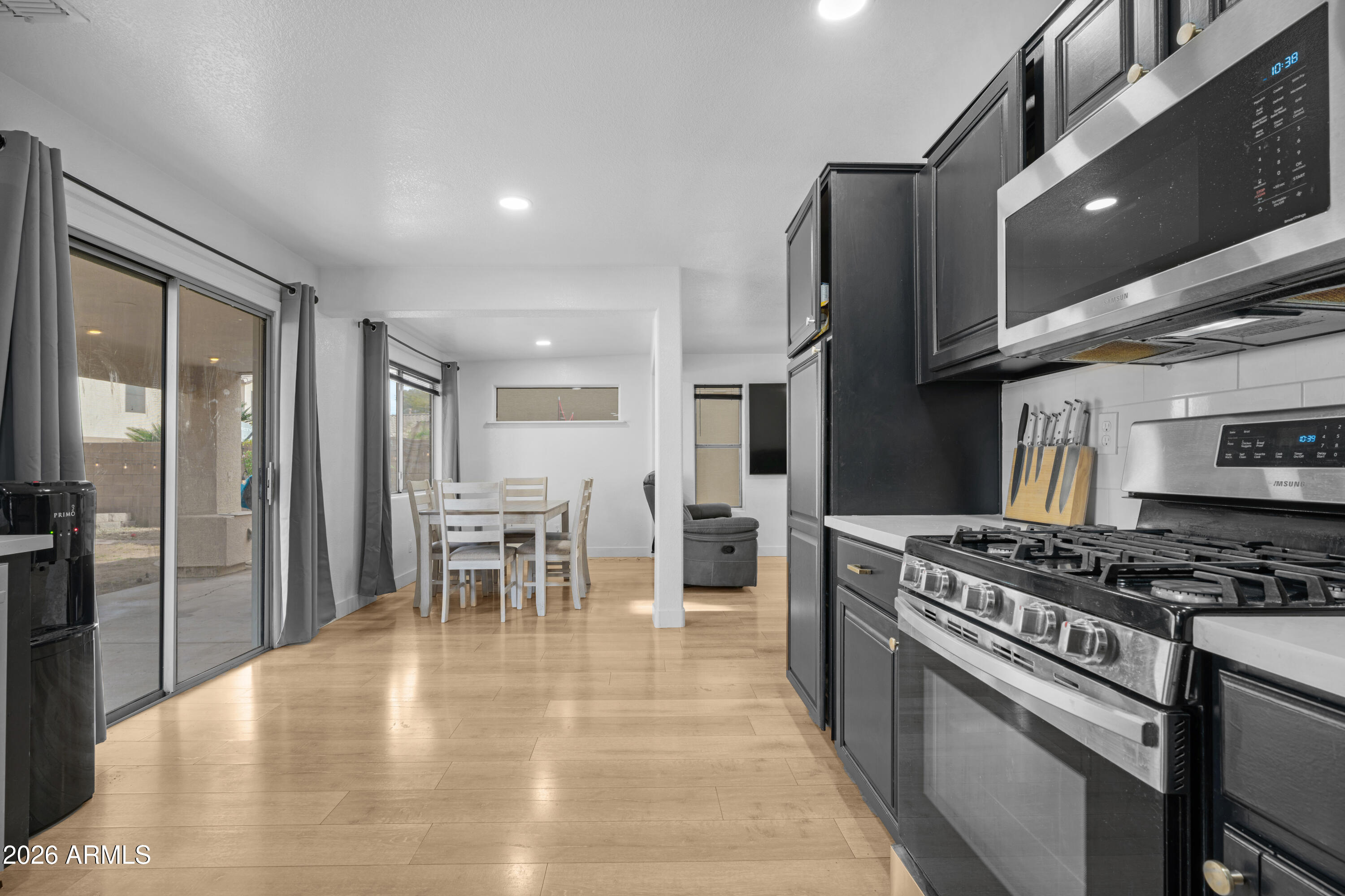 1810 East Milky Way Gilbert, AZ 85295 - Photo 15 of 46 a kitchen with stainless steel appliances granite countertop a stove top oven a sink and a table