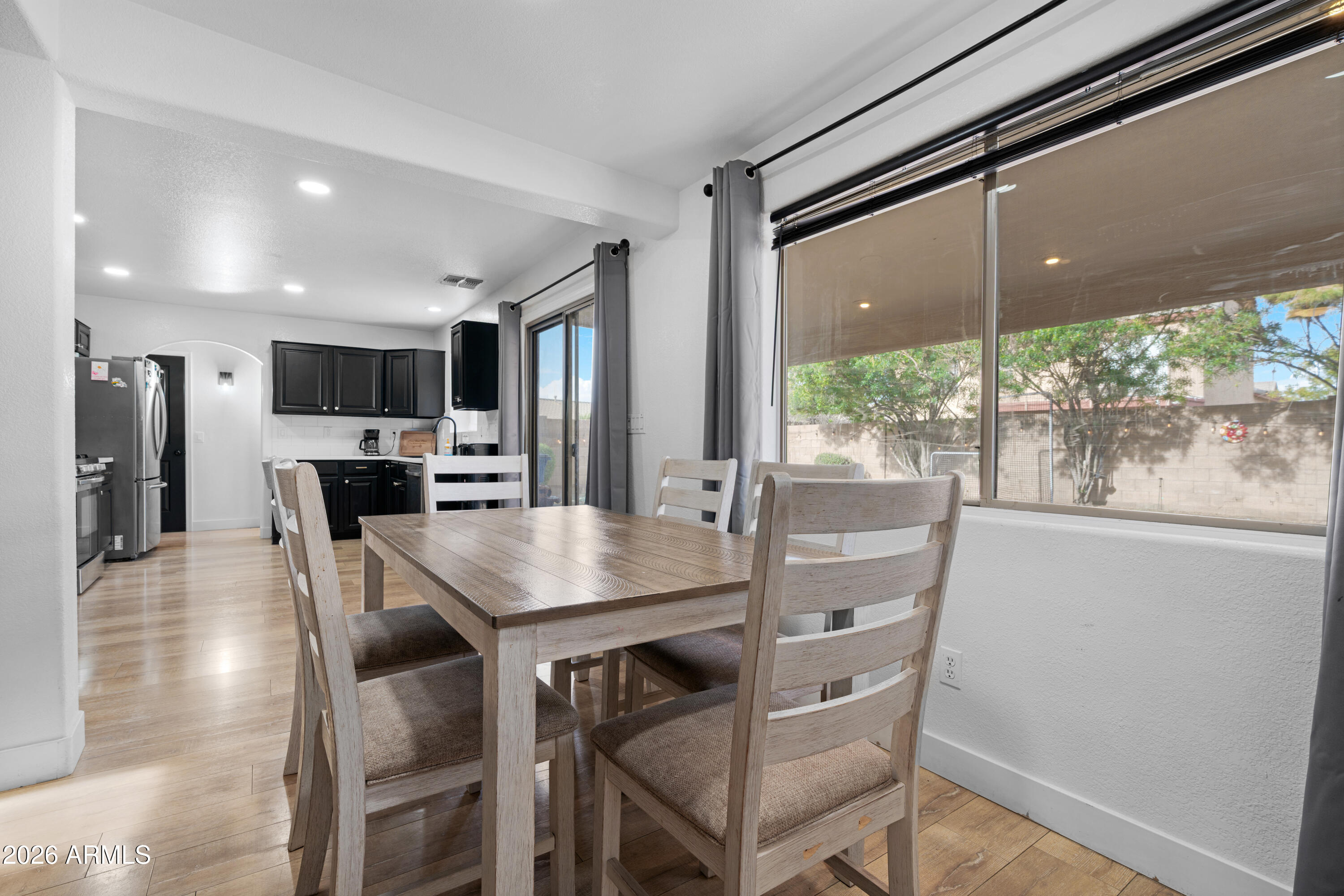 1810 East Milky Way Gilbert, AZ 85295 - Photo 16 of 46 a view of a dining room with furniture window and wooden floor