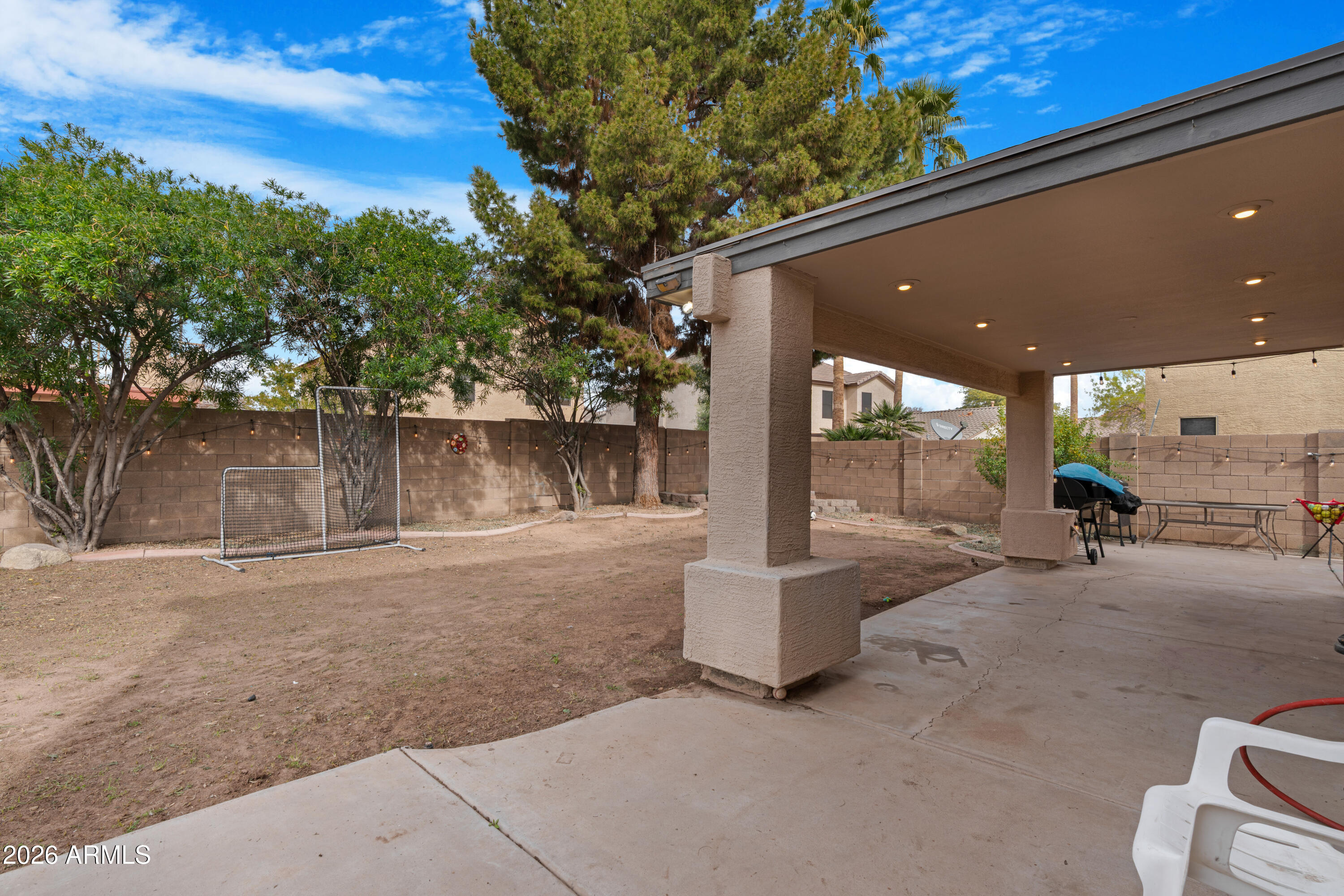1810 East Milky Way Gilbert, AZ 85295 - Photo 34 of 46 a view of a patio with table and chairs with wooden fence