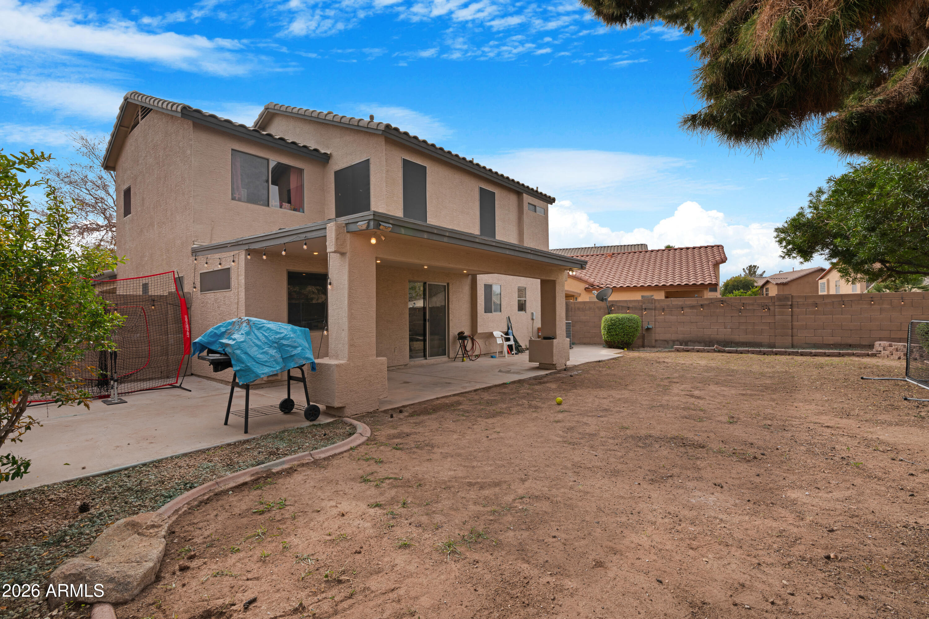 1810 East Milky Way Gilbert, AZ 85295 - Photo 35 of 46 a view of a house with a yard and table and chairs under an umbrella